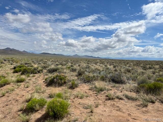 Lot 7 Jack Road Sanford, CO 81151 - Photo 2 of 11 a view of a forest with mountains in the background