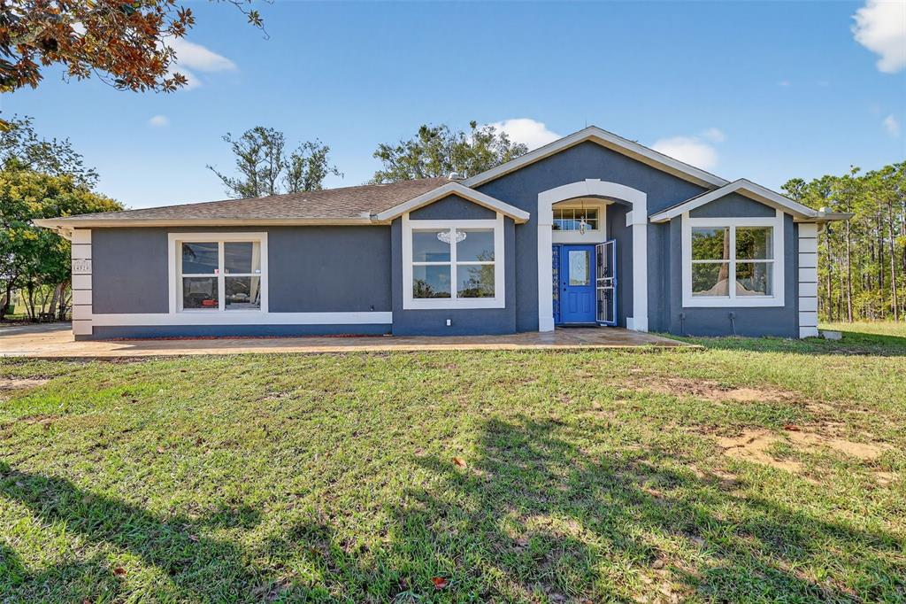 14520 Lost Lake Road Clermont, FL 34711 - Photo 3 of 47 a front view of a house with a garden