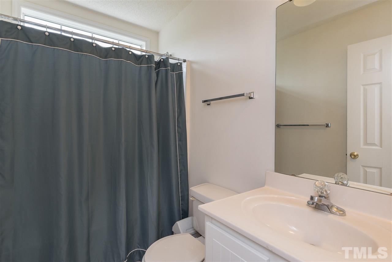 2305 Dahlgreen Road Raleigh, NC 27615 - Photo 14 of 19 a bathroom with a sink mirror vanity and toilet