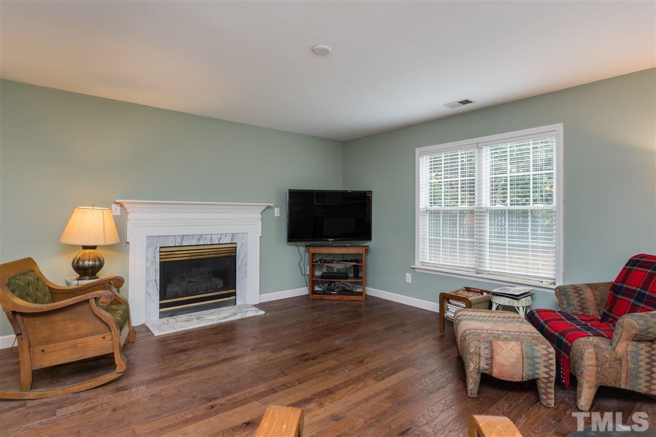 2305 Dahlgreen Road Raleigh, NC 27615 - Photo 4 of 19 a living room with furniture a flat screen tv and a fireplace