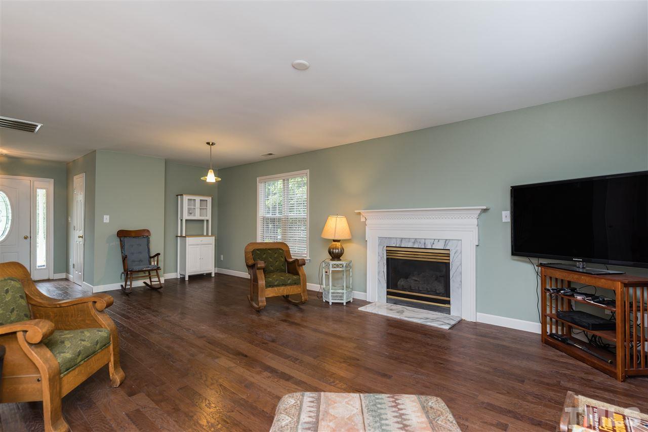 2305 Dahlgreen Road Raleigh, NC 27615 - Photo 6 of 19 a living room with furniture and a fireplace or television