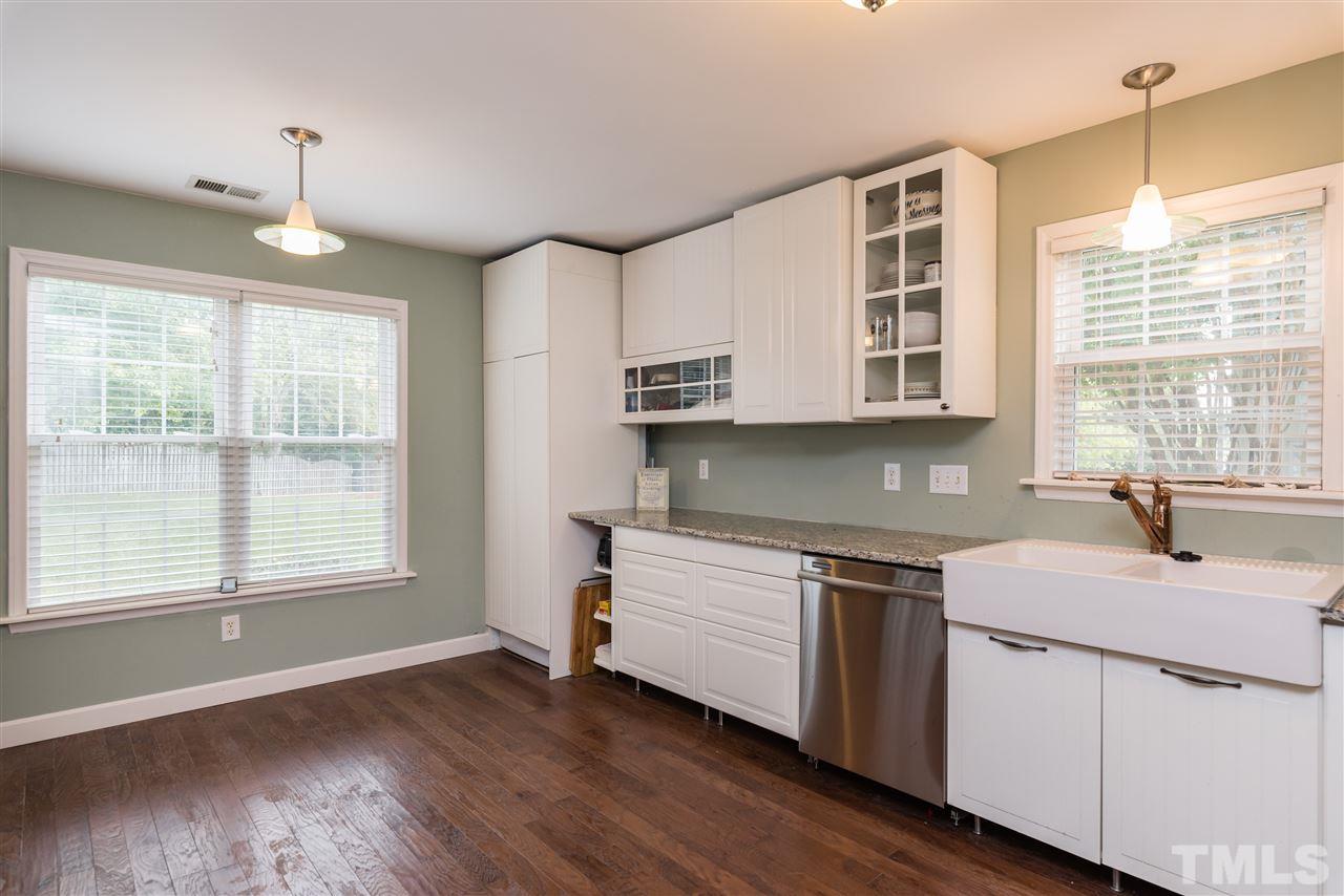 2305 Dahlgreen Road Raleigh, NC 27615 - Photo 8 of 19 a kitchen with stainless steel appliances granite countertop a sink stove and wooden floor