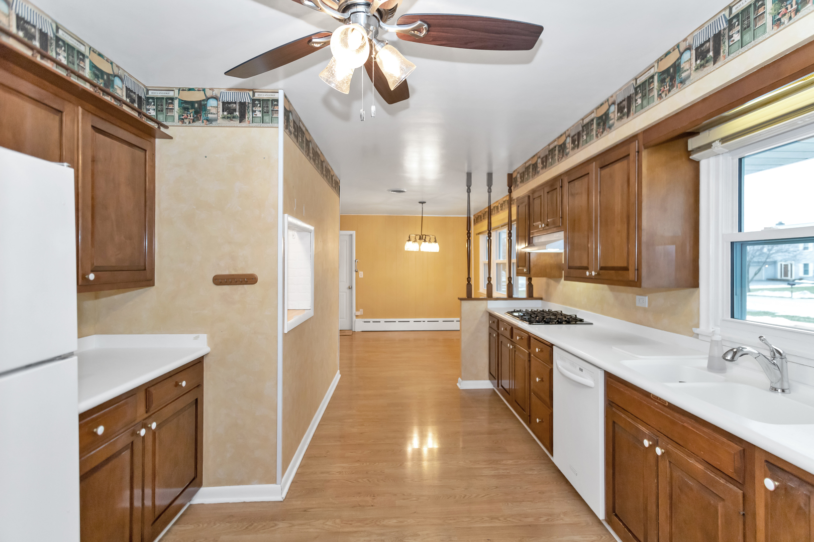 1700 Kay Road Wheaton, IL 60187 - Photo 12 of 38 a kitchen with stainless steel appliances a sink cabinets and wooden floor