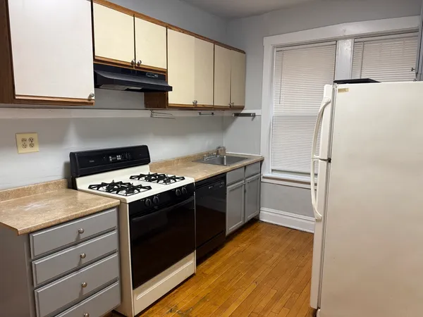 a kitchen with a stove and a refrigerator