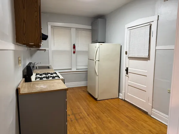 a kitchen with a refrigerator a stove a microwave and cabinets