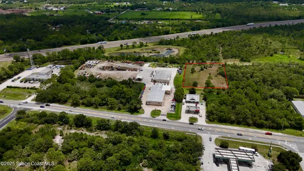 an aerial view of a house with a garden and lake view