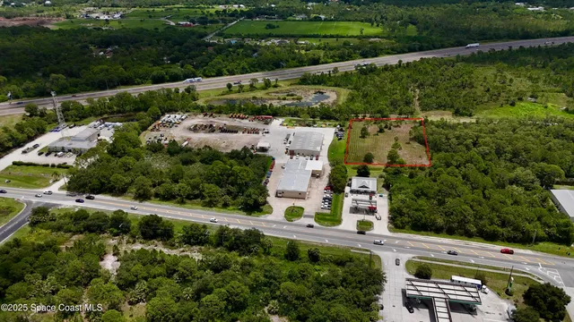 an aerial view of a house with a garden and lake view