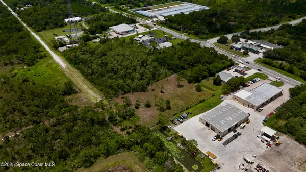 an aerial view of multiple houses with yard