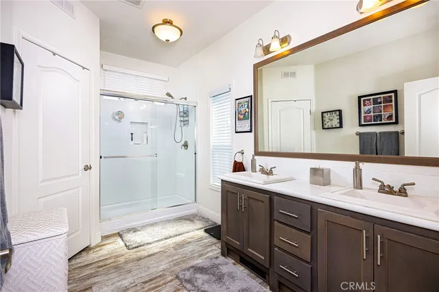 a spacious bathroom with a double vanity sink mirror and shower