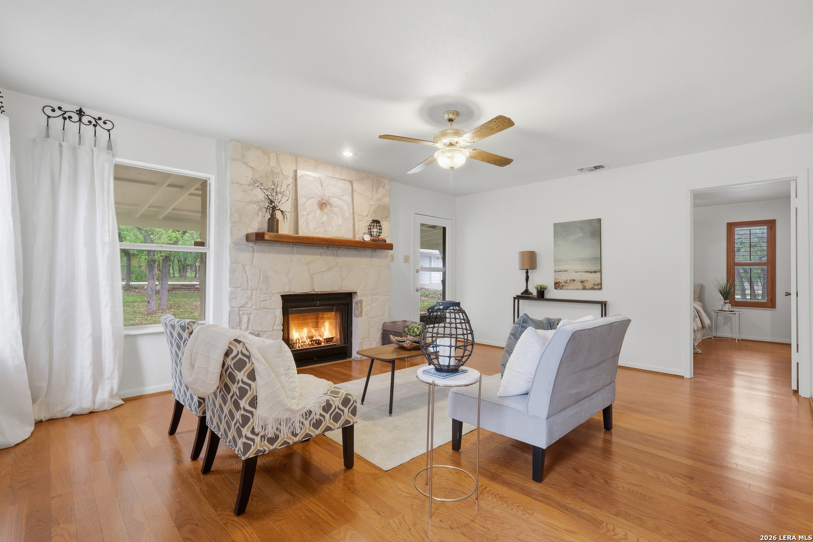 261 Fawn Lane Spring Branch, TX 78070 - Photo 10 of 44 a living room with fireplace furniture and a wooden floor
