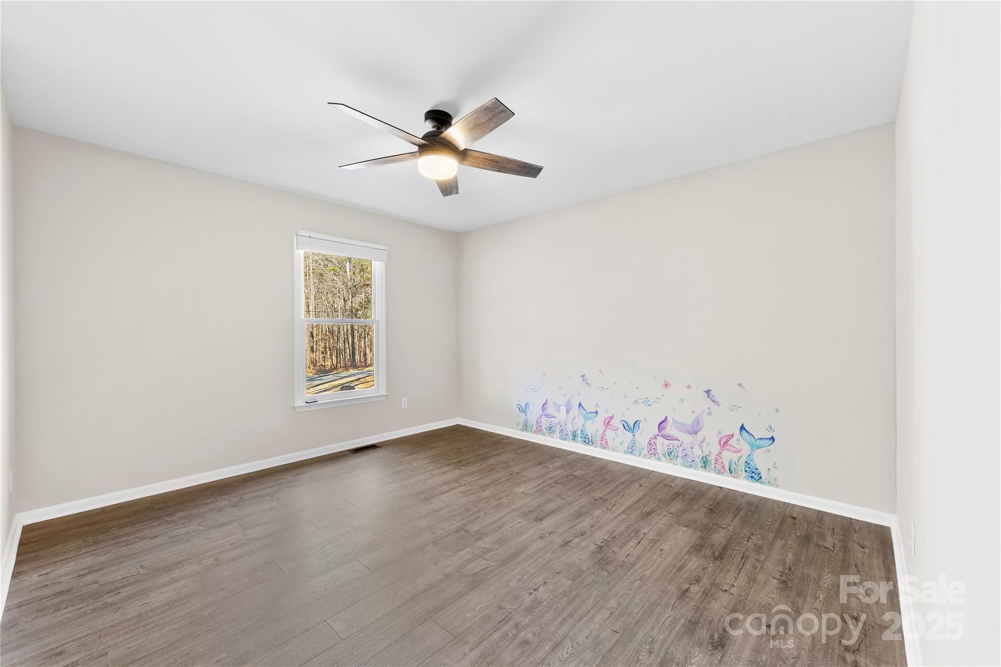 16218 Barbee Road Stanfield, NC 28163 - Photo 11 of 30 an empty room with wooden floor and window