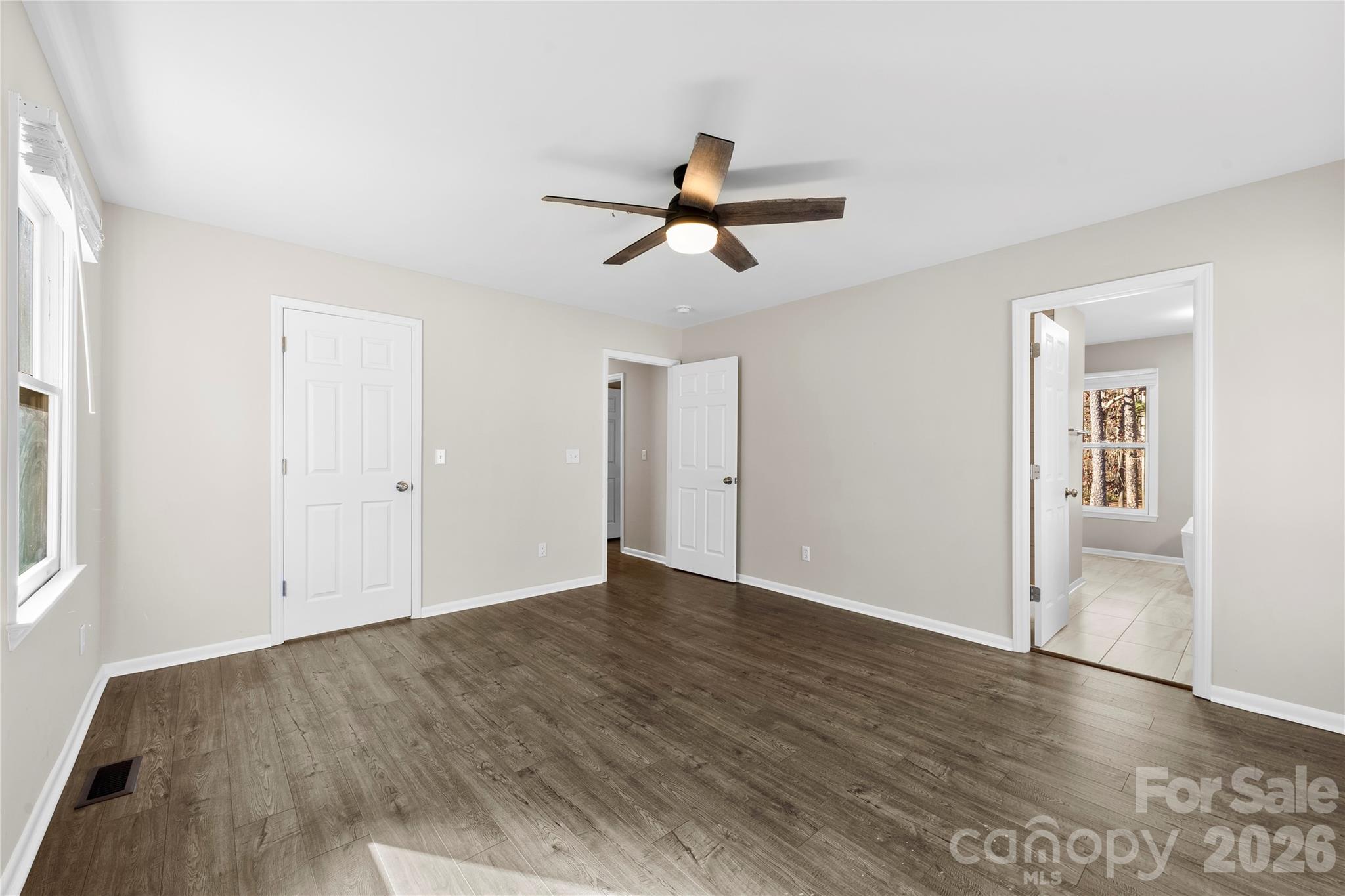 16218 Barbee Road Stanfield, NC 28163 - Photo 14 of 30 an empty room with wooden floor and windows