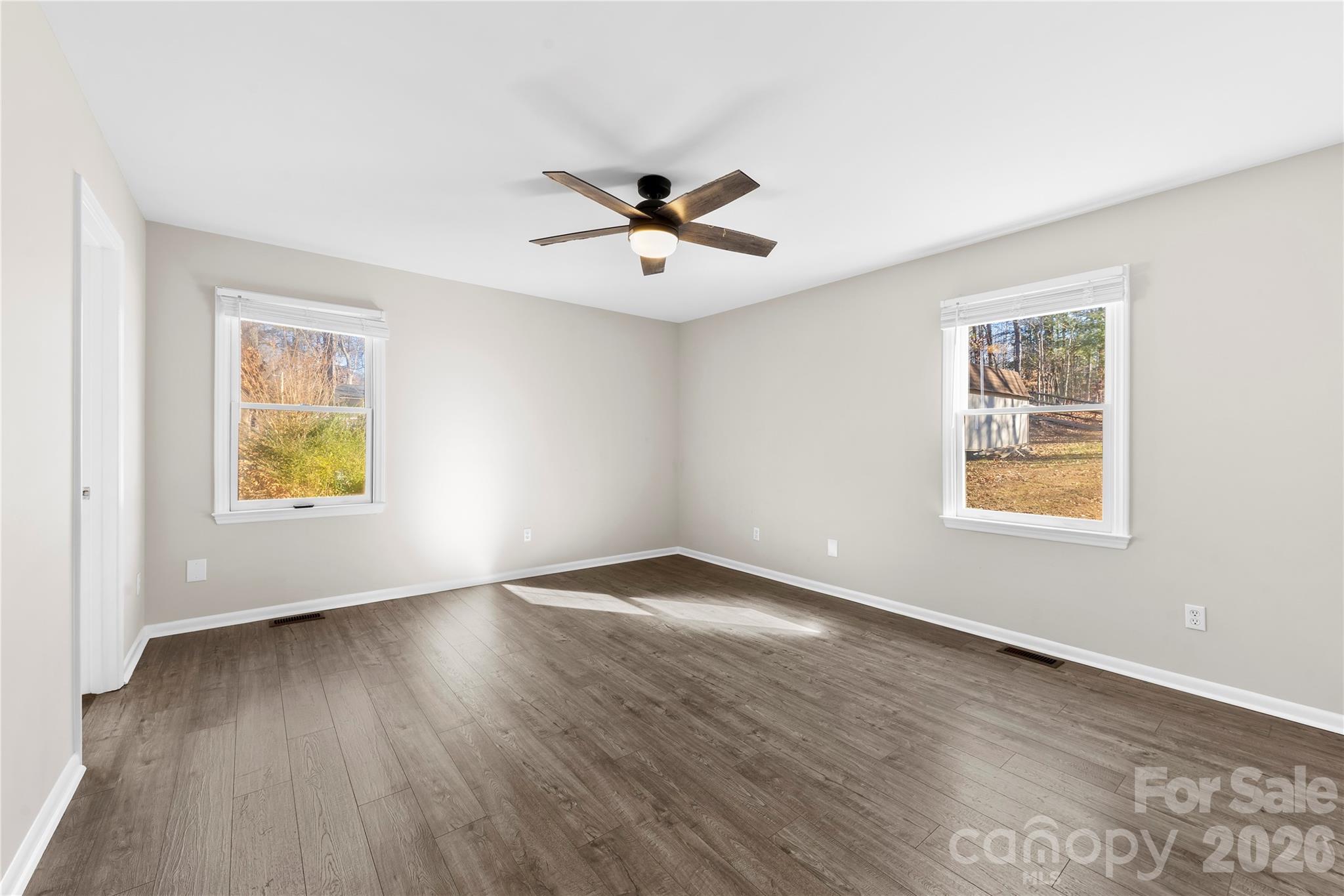 16218 Barbee Road Stanfield, NC 28163 - Photo 15 of 30 a view of an empty room with window and wooden floor