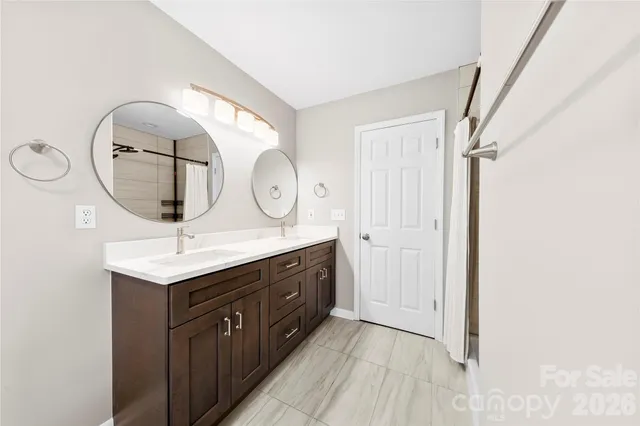 a bathroom with a sink a mirror and a shower