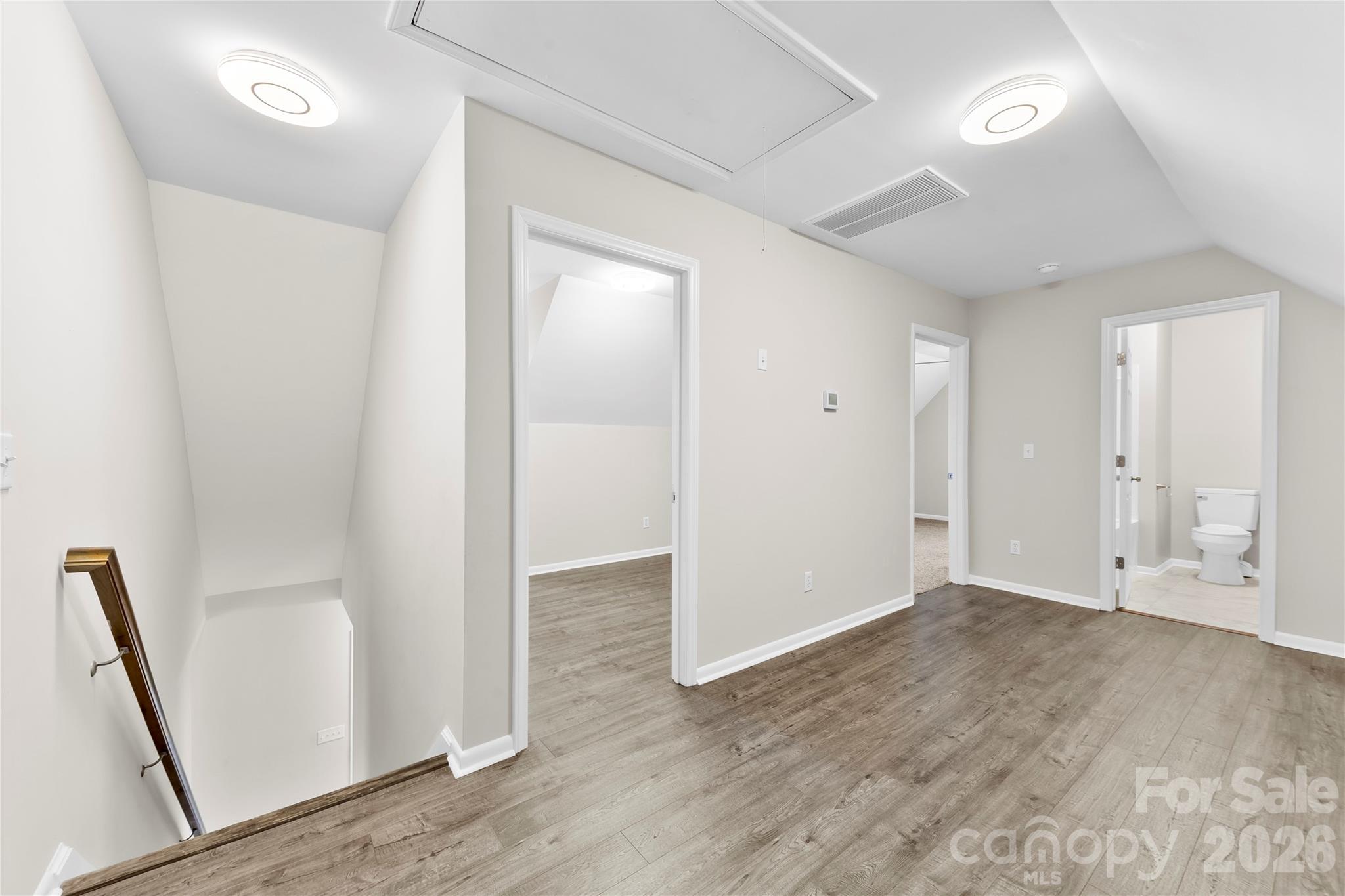 16218 Barbee Road Stanfield, NC 28163 - Photo 17 of 30 an empty room with wooden floor and entrance