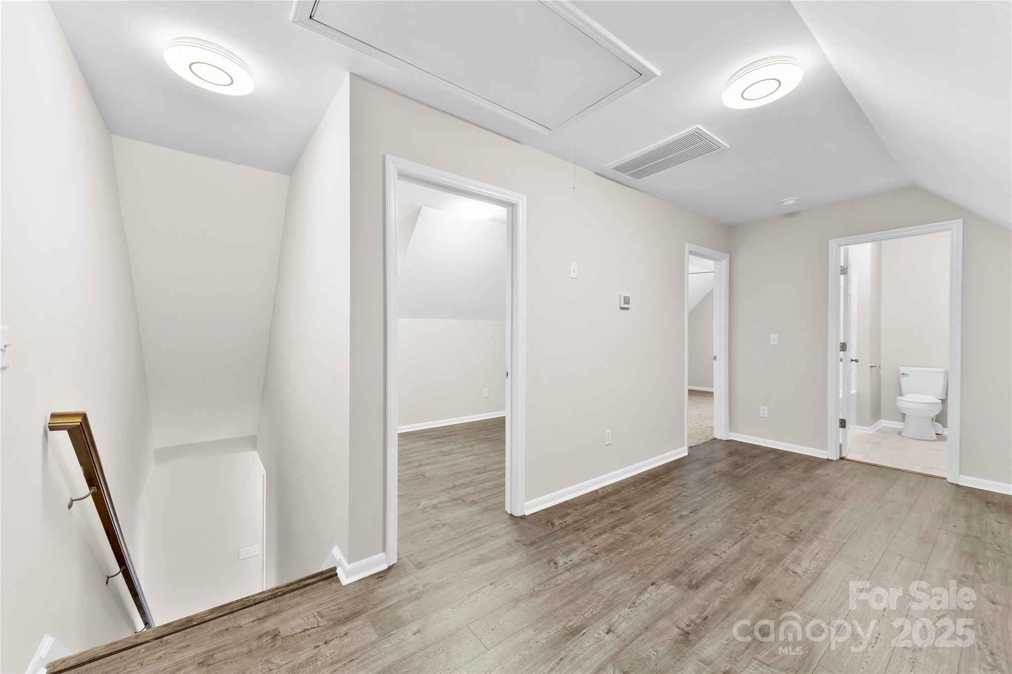 16218 Barbee Road Stanfield, NC 28163 - Photo 17 of 30 an empty room with wooden floor and entrance