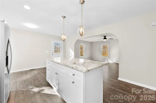 a bathroom with a granite countertop sink a mirror and a shower