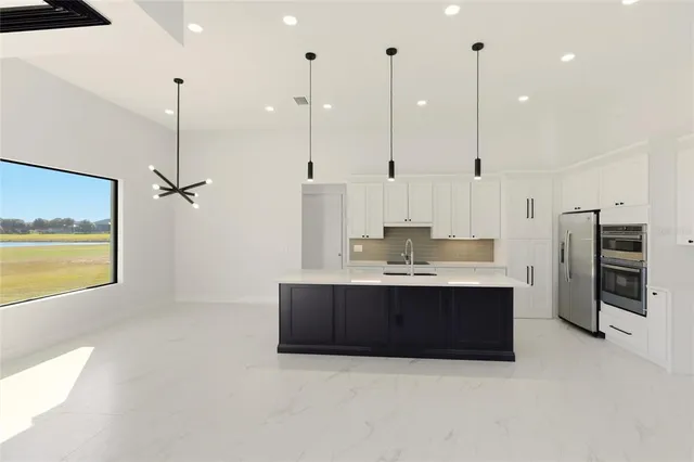 a view of an empty room with a painting on the wall