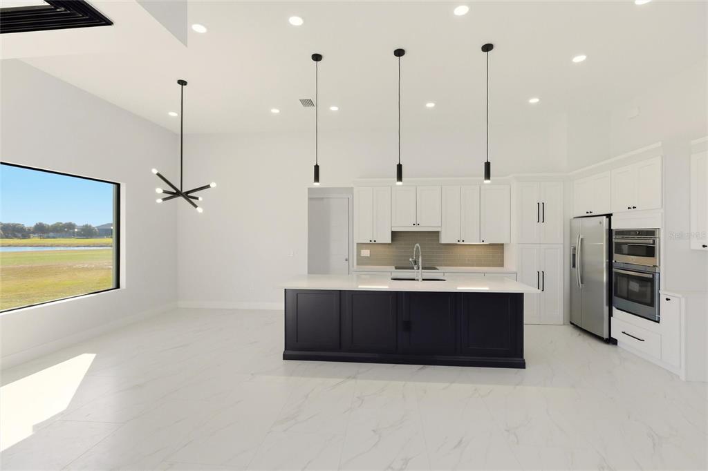 17 Long Meadow Road Rotonda West, FL 33947 - Photo 11 of 37 a view of kitchen with stainless steel appliances granite countertop cabinets and a view of living room