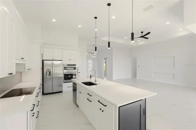 a kitchen with white cabinets and white appliances
