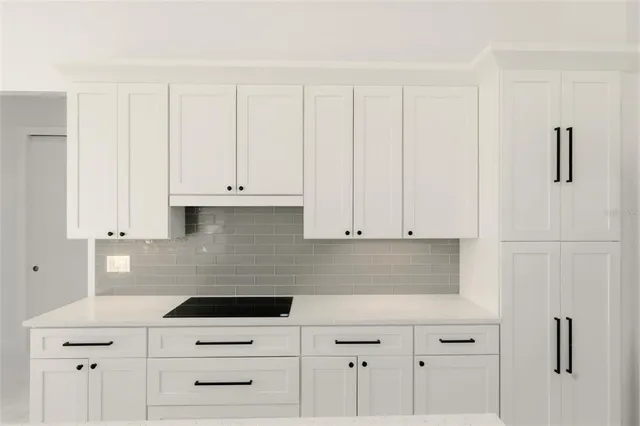 a kitchen with refrigerator and stove