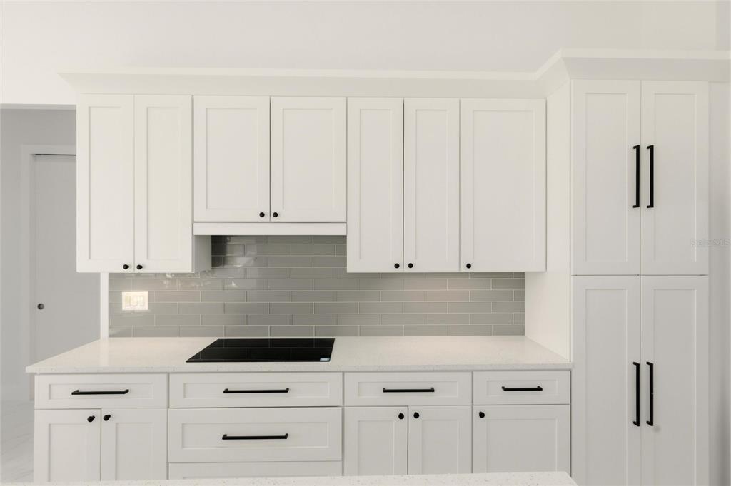 17 Long Meadow Road Rotonda West, FL 33947 - Photo 15 of 37 a kitchen with white cabinets and white appliances