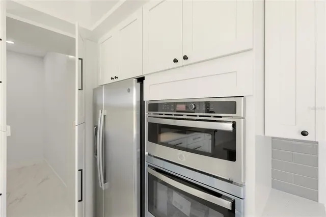 a view of a room with a fan and a window