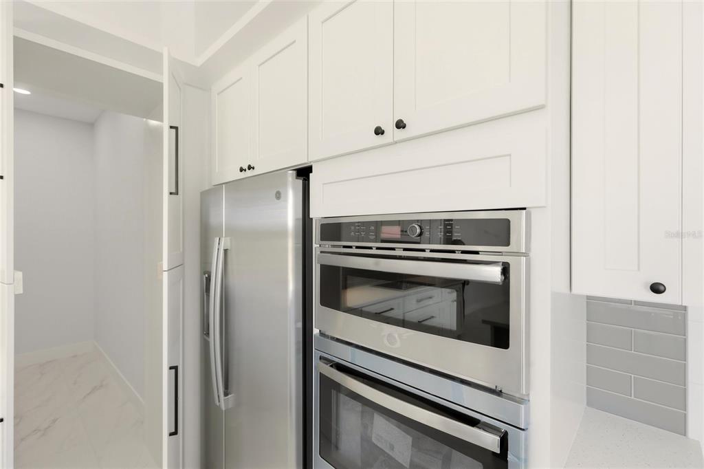 17 Long Meadow Road Rotonda West, FL 33947 - Photo 16 of 37 a kitchen with refrigerator and stove