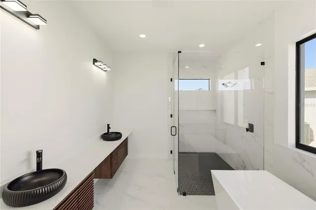 a bathroom with a bathtub and a shower