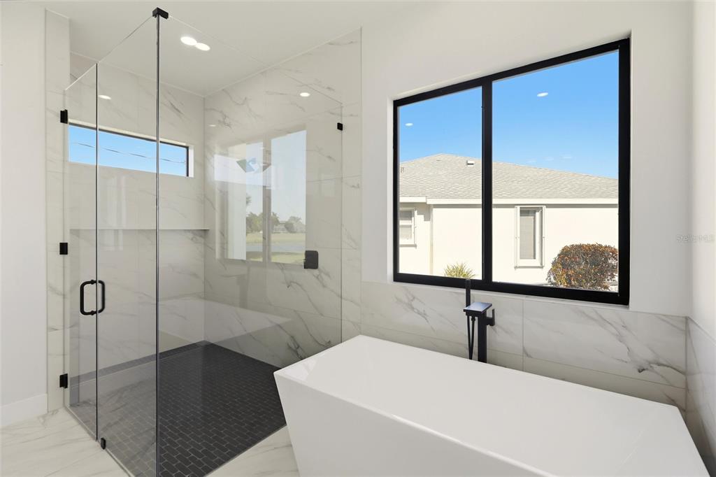 17 Long Meadow Road Rotonda West, FL 33947 - Photo 24 of 37 a bathroom with a bathtub and a shower