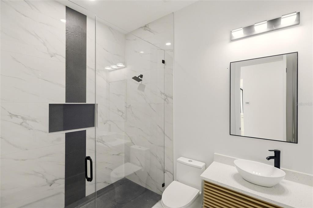 17 Long Meadow Road Rotonda West, FL 33947 - Photo 26 of 37 a bathroom with a sink a toilet and shower