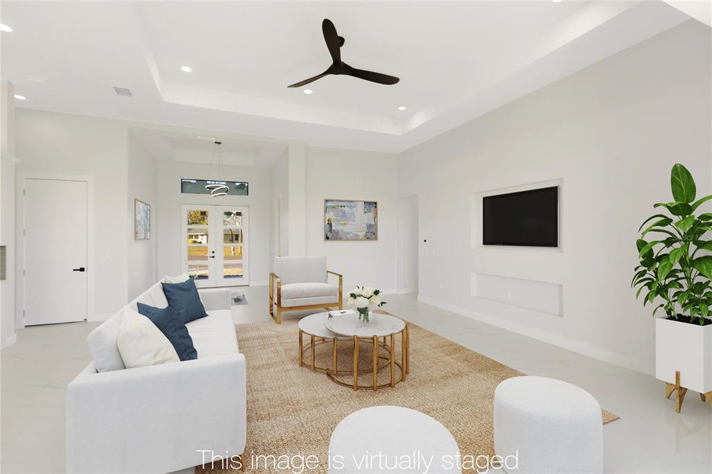 17 Long Meadow Road Rotonda West, FL 33947 - Photo 3 of 37 a living room with furniture and a flat screen tv