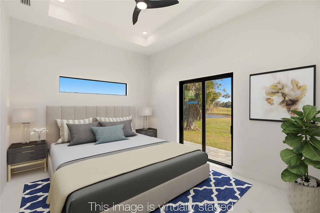 17 Long Meadow Road Rotonda West, FL 33947 - Photo 4 of 37 a bedroom with a large bed and a potted plant