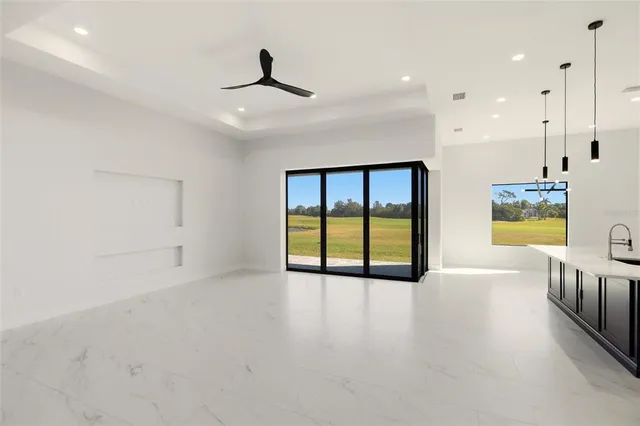 a large white kitchen with a large window