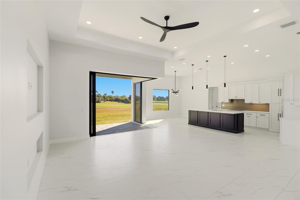 17 Long Meadow Road Rotonda West, FL 33947 - Photo 7 of 37 a large white kitchen with a large window