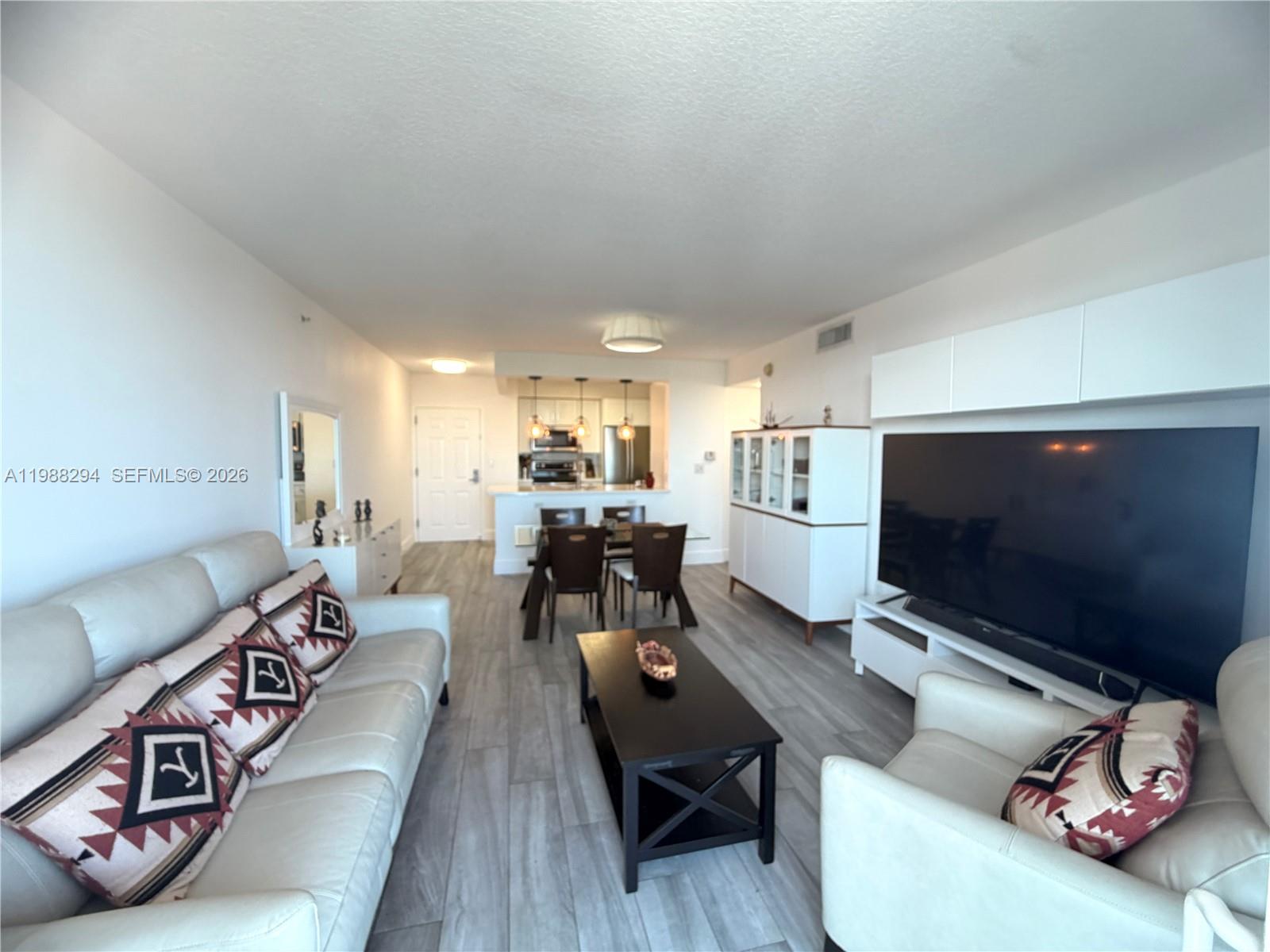 900 Southwest 8th Street, Unit 1509 Miami, FL 33130 - Photo 15 of 37 a living room with furniture and a flat screen tv
