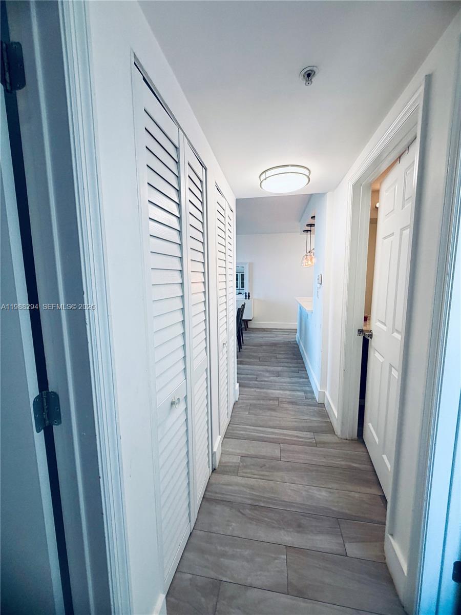 900 Southwest 8th Street, Unit 1509 Miami, FL 33130 - Photo 19 of 37 a view of a hallway with wooden floor and staircase