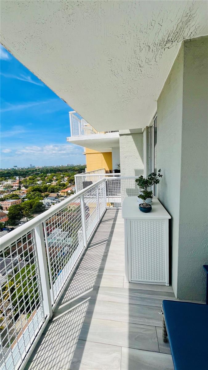 900 Southwest 8th Street, Unit 1509 Miami, FL 33130 - Photo 2 of 37 a view of a balcony with wooden floor