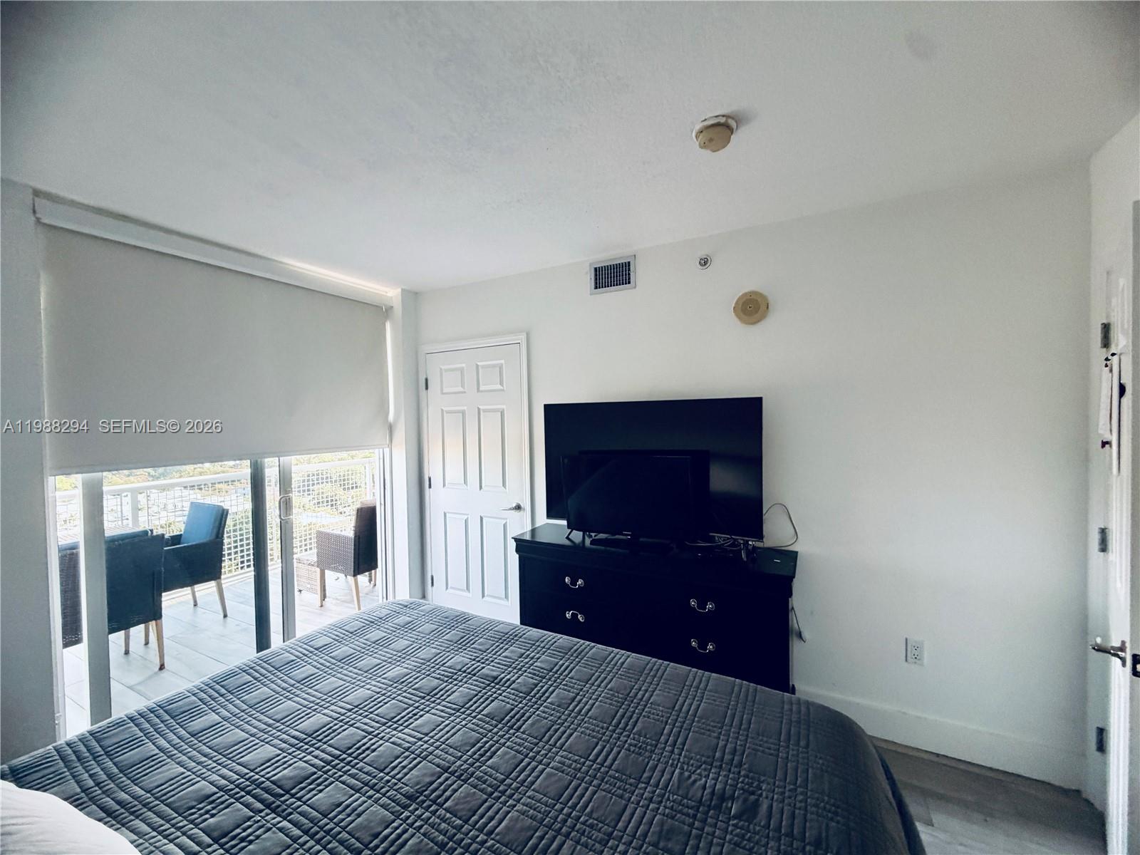 900 Southwest 8th Street, Unit 1509 Miami, FL 33130 - Photo 21 of 37 a bedroom with a bed and a flat screen tv