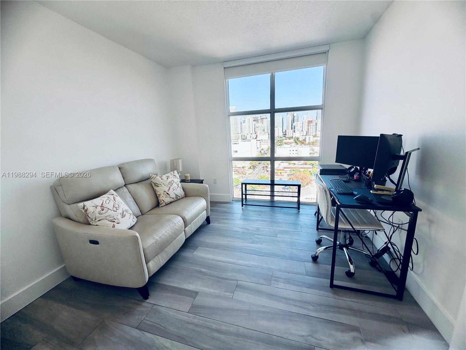 900 Southwest 8th Street, Unit 1509 Miami, FL 33130 - Photo 23 of 37 a living room with furniture and a wooden floor