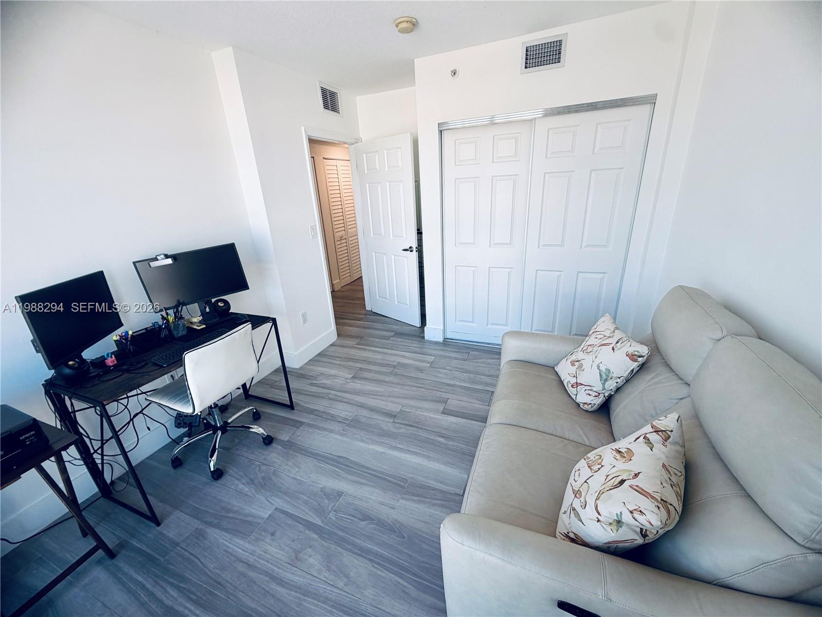 900 Southwest 8th Street, Unit 1509 Miami, FL 33130 - Photo 24 of 37 a view of a workspace with furniture and wooden floor