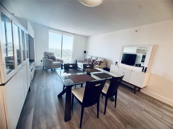 a view of a dining room with furniture and wooden floor