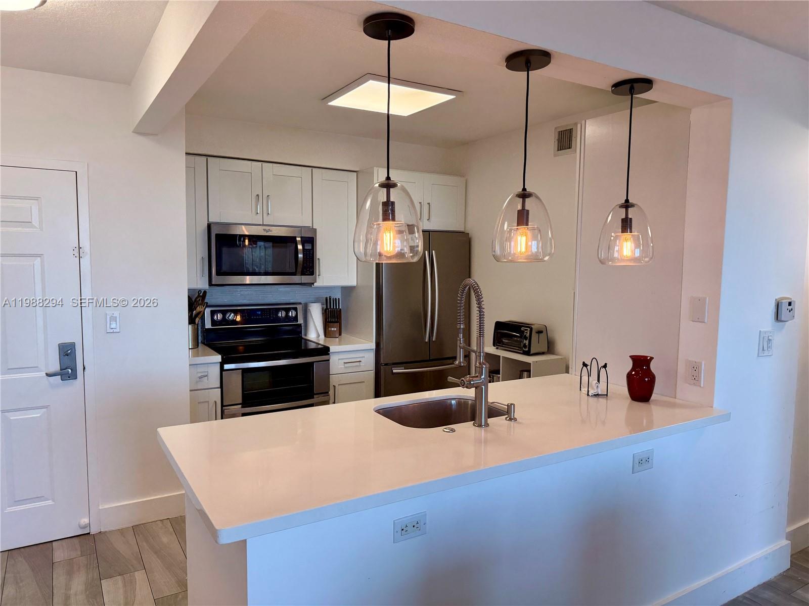 900 Southwest 8th Street, Unit 1509 Miami, FL 33130 - Photo 9 of 37 a kitchen with a refrigerator a stove and a sink