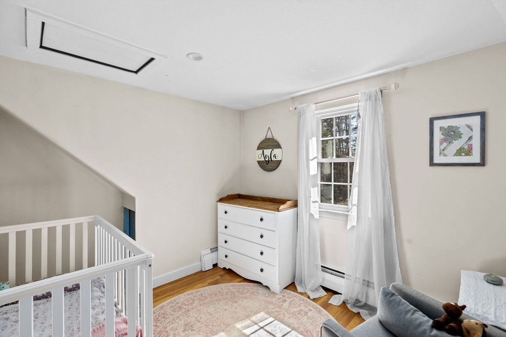 742 Broadway Hanover, MA 02339 - Photo 15 of 42 a bedroom with furniture and baby crib