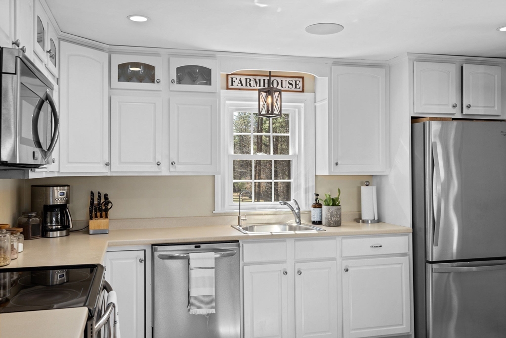742 Broadway Hanover, MA 02339 - Photo 3 of 42 a kitchen with stainless steel appliances granite countertop a refrigerator sink and cabinets