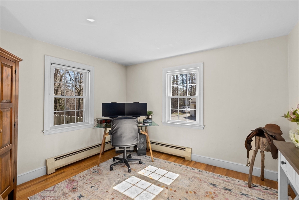 742 Broadway Hanover, MA 02339 - Photo 10 of 42 a view of a workspace with wooden floor and a window