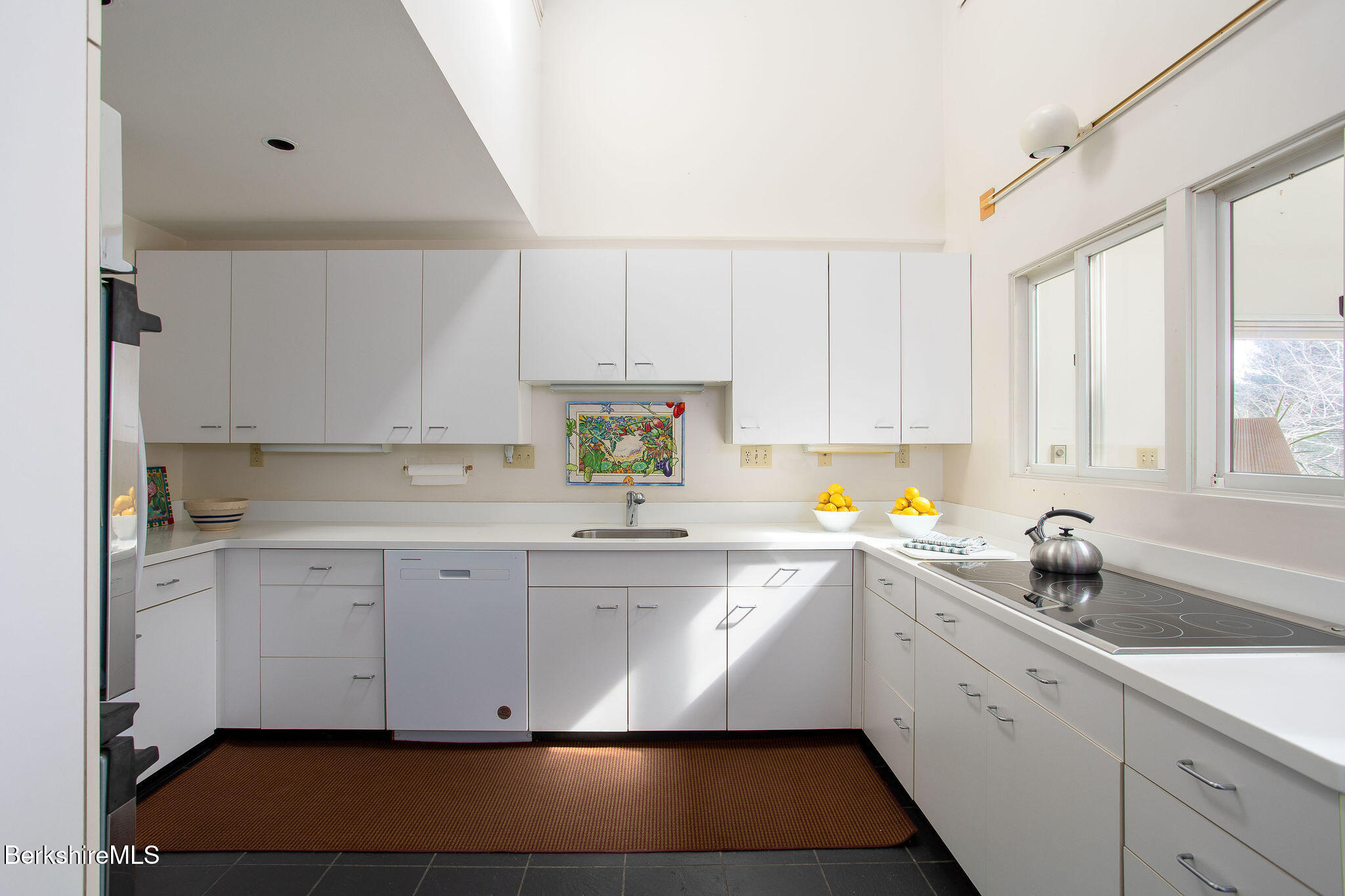 103 Gravesleigh Terrace Pittsfield, MA 01201 - Photo 16 of 46 a kitchen with a sink dishwasher a stove and white cabinets
