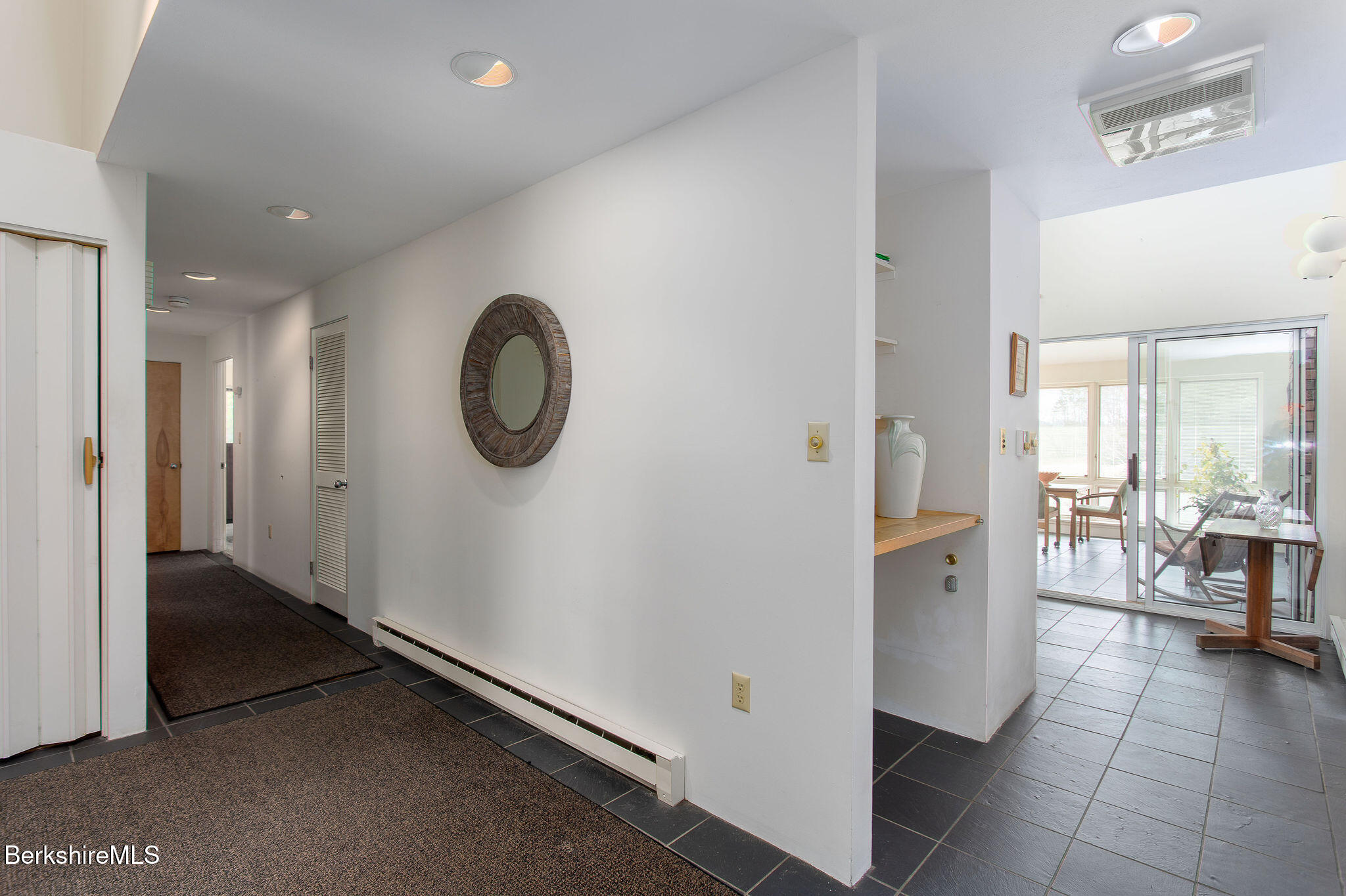 103 Gravesleigh Terrace Pittsfield, MA 01201 - Photo 8 of 46 a view of a hallway with dining area and chandelier