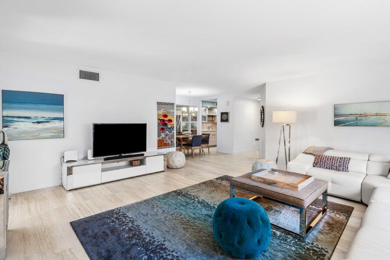 1700 South Ocean Boulevard, Unit 1 Delray Beach, FL 33483 - Photo 12 of 39 a living room with furniture and a flat screen tv