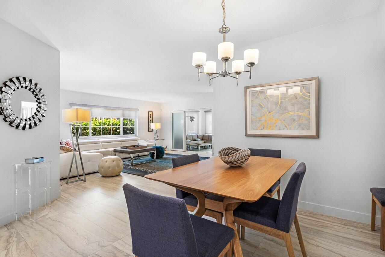 1700 South Ocean Boulevard, Unit 1 Delray Beach, FL 33483 - Photo 15 of 39 a view of a dining room with furniture a chandelier and wooden floor